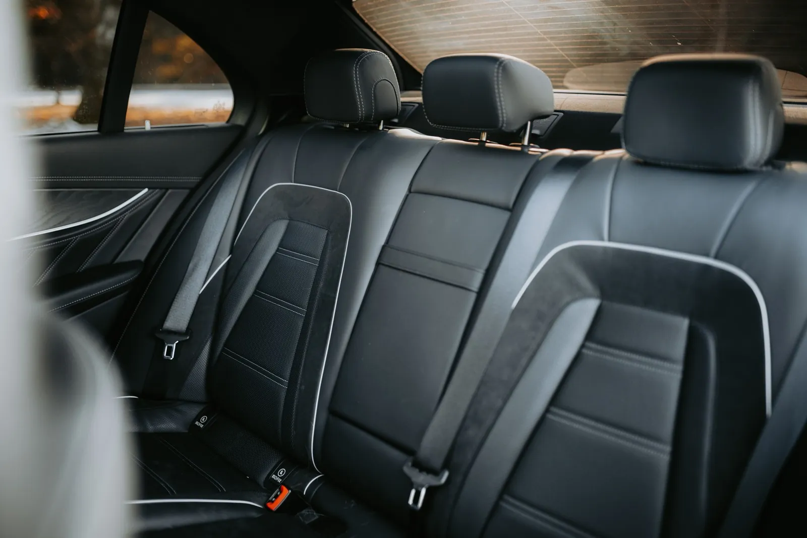Back seat of a car with black leather upholstery