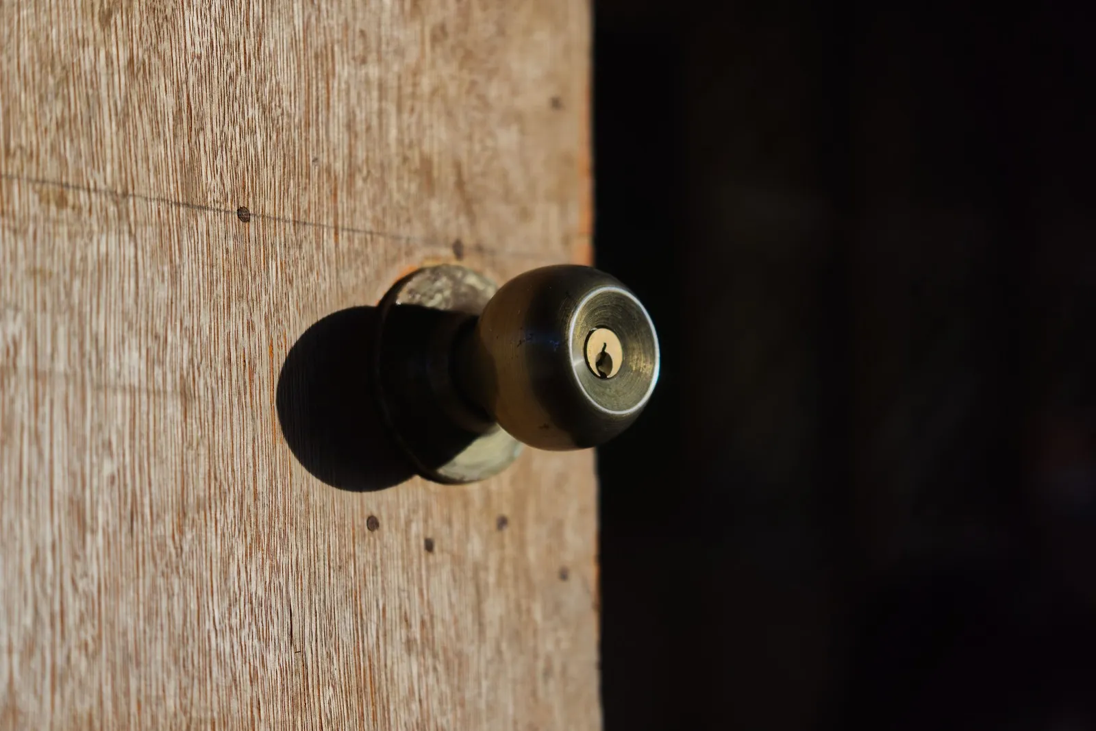 Knob lock with a keyhole on a wooden door