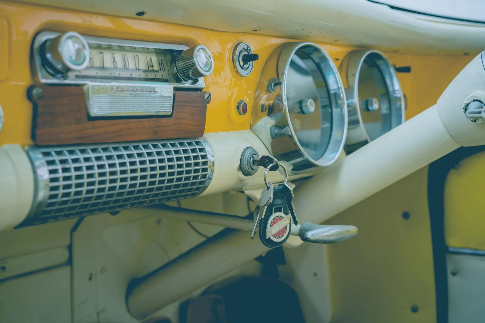 Key in the ignition of a vintage car dashboard