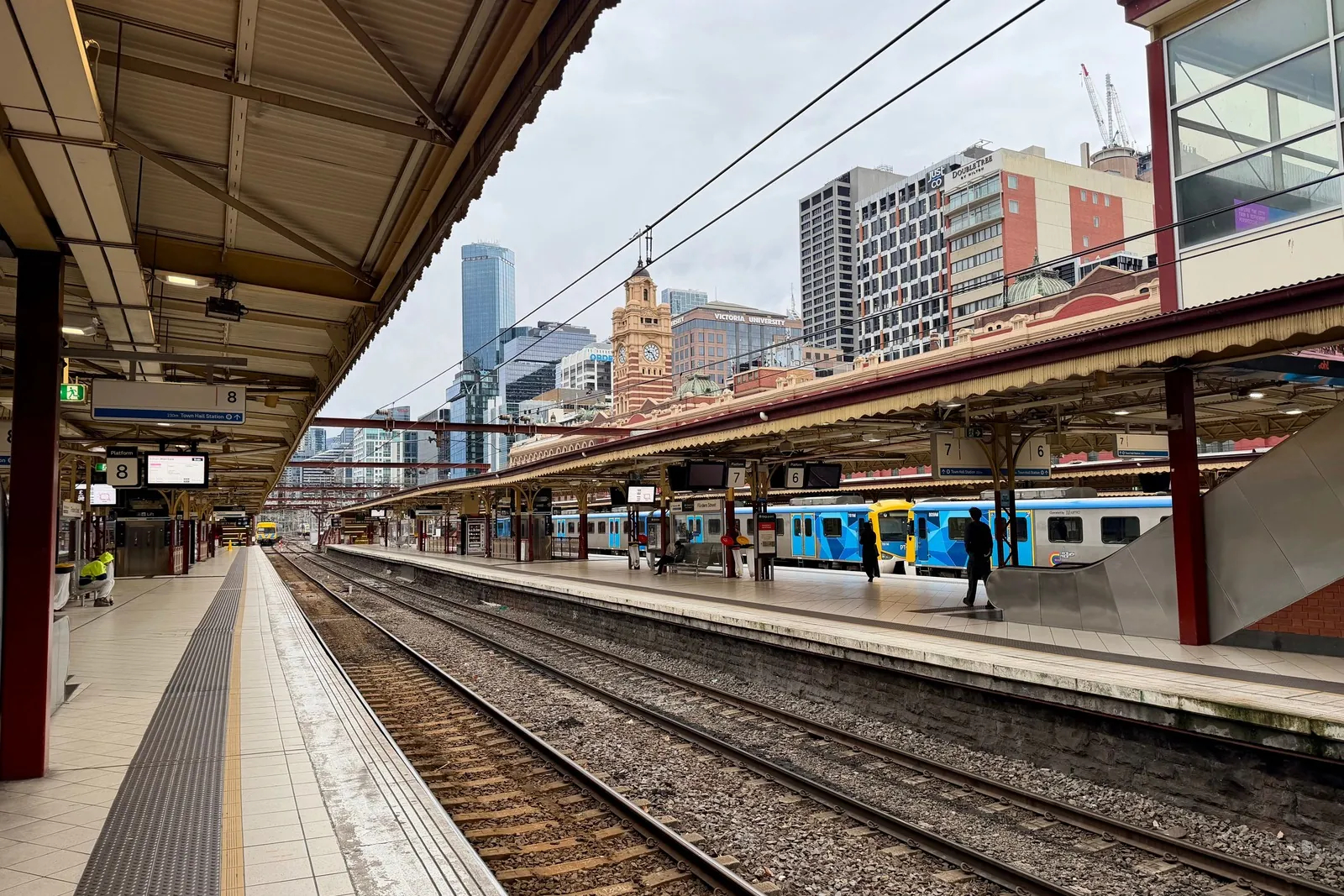 Empty outdoor train platform beside the tracks