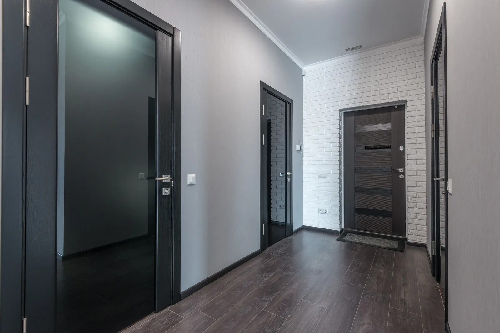 Apartment building hallway with dark doors on both sides