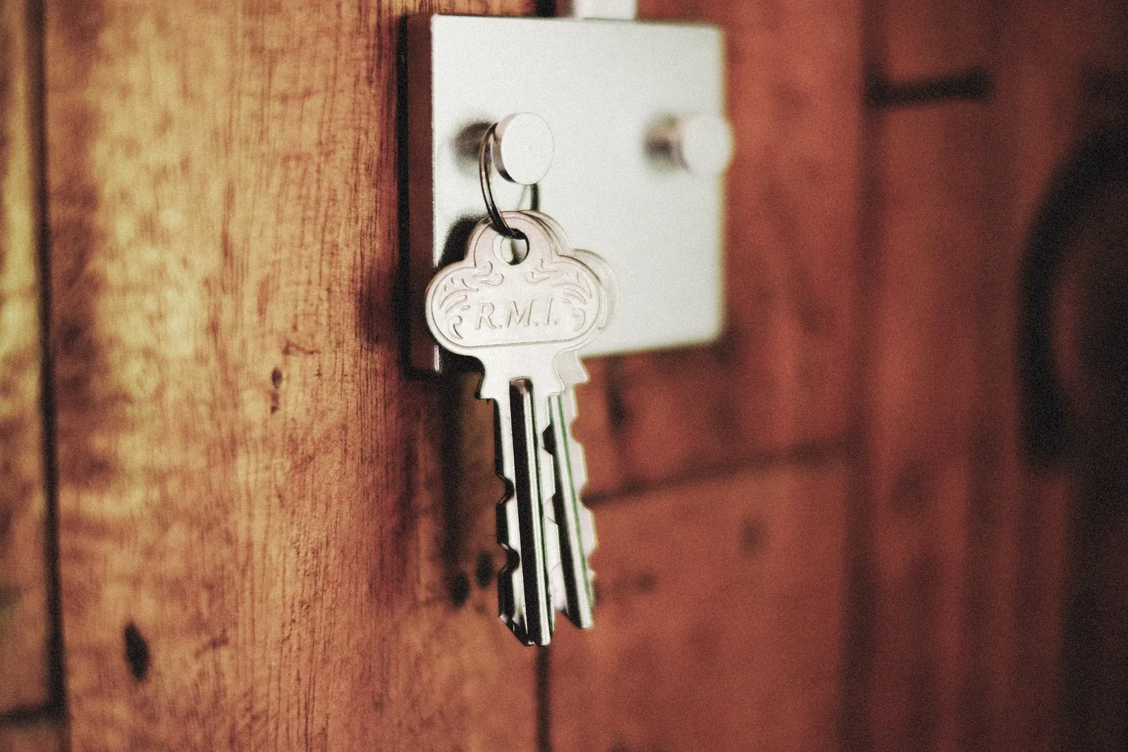 Keys hanging from a lock on a wooden door