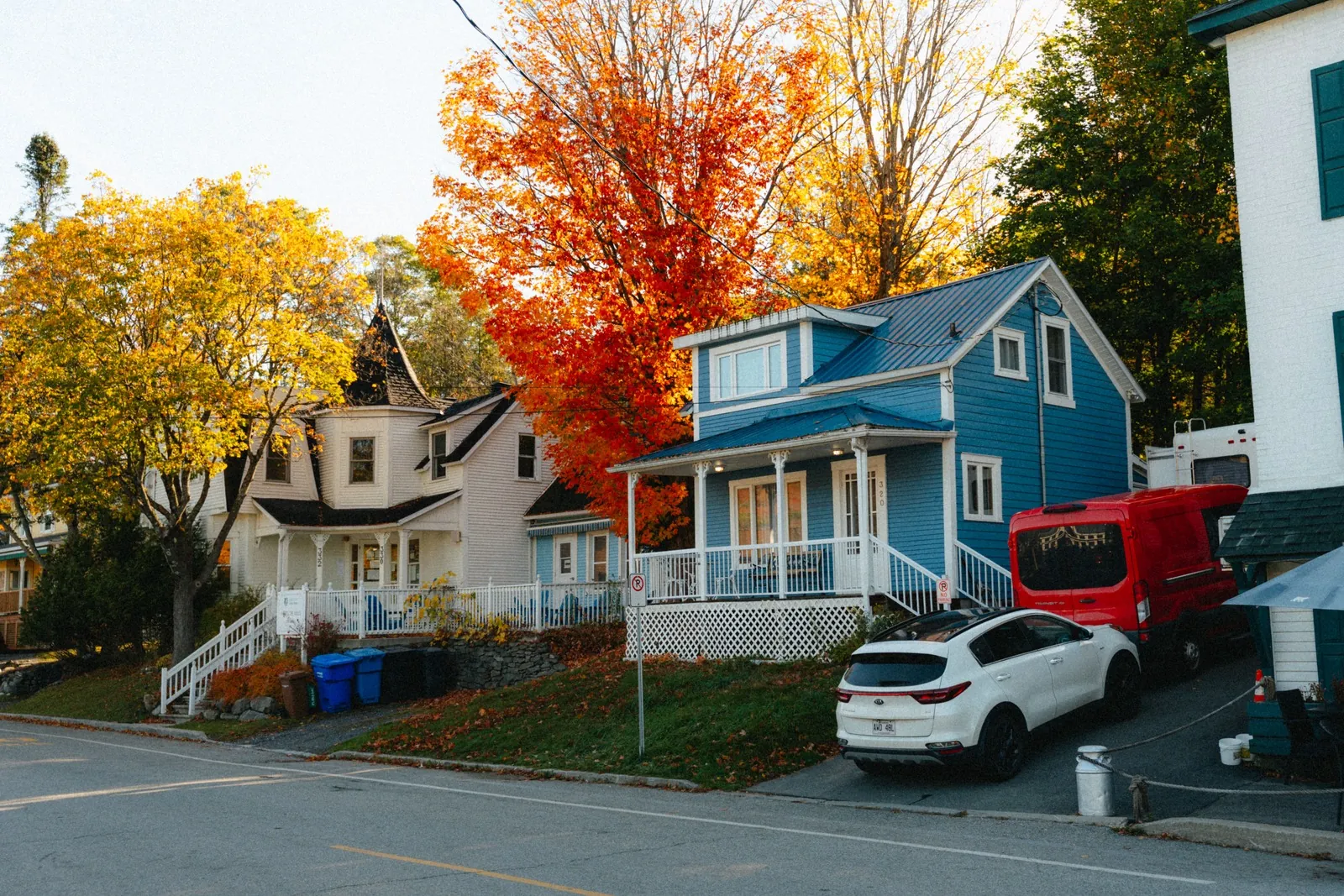 Suburban street of wood-frame houses under autumn trees